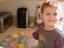 Hunter fills the cupcakes tins.
