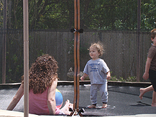Ryder on the trampoline with mom and Hunter.