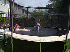 Ryder on the trampoline with mom and Hunter.